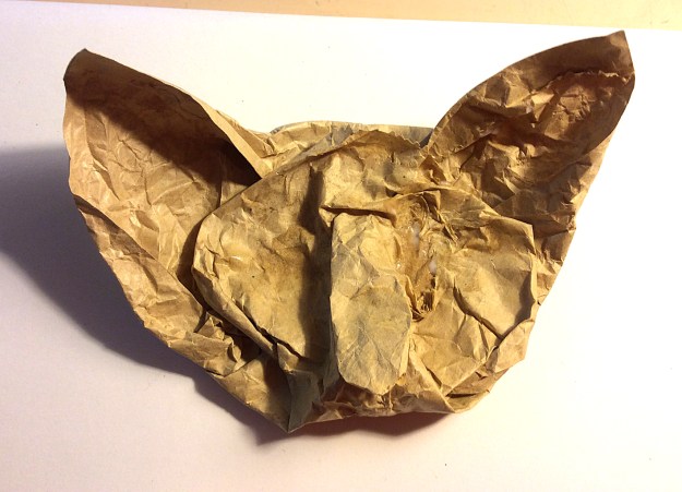 I started with the head. The corners of the paper lunch bag practically made the cat's ears on their own.