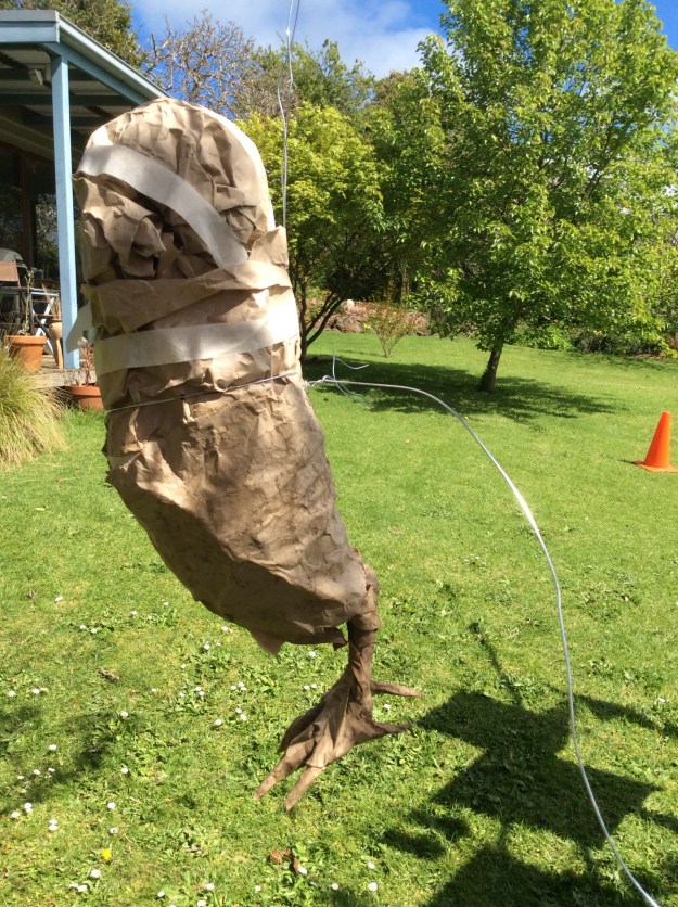 Mr Owl hanging from the clothes line, with some serious surgery about to begin. Some wire (which I could not get to go through his paper middle - not surprisingly) is tied around him to form the basis of his wings. 